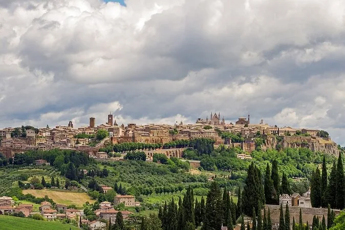Orvieto spread along its ridge above green countryside, the Duomo's spires on the skyline